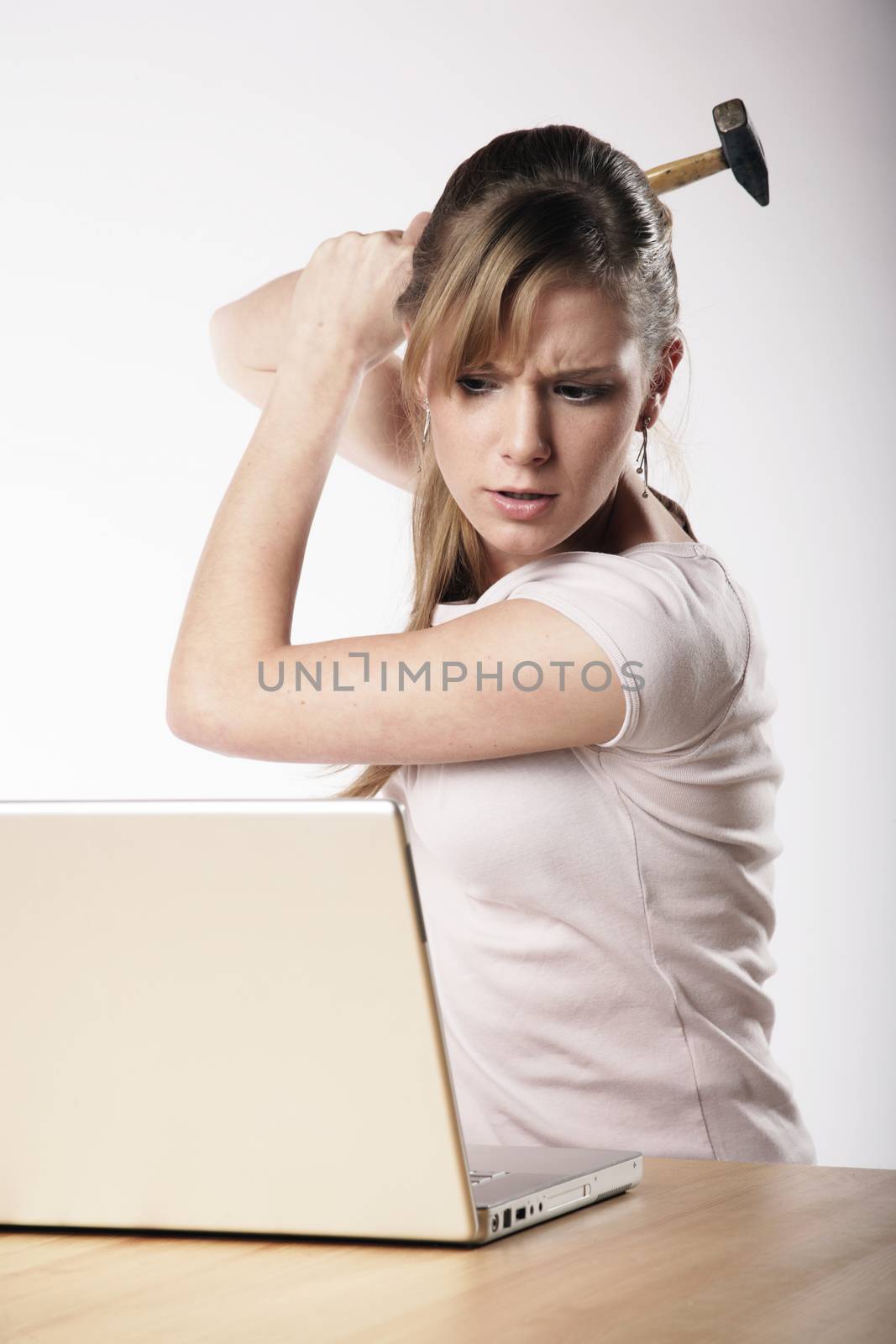 Woman strikes with a hammer to her computer