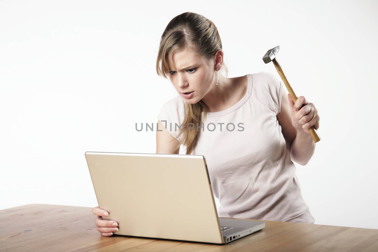 Woman strikes with a hammer to her computer