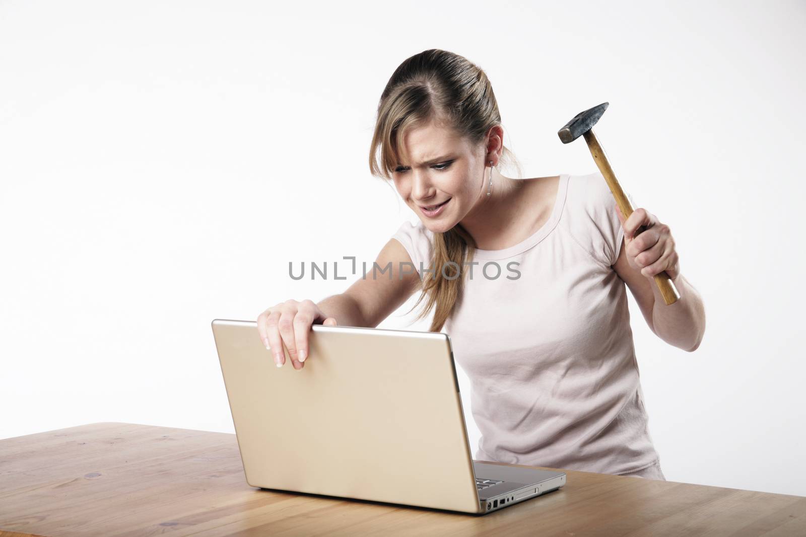 Woman strikes with a hammer to her computer