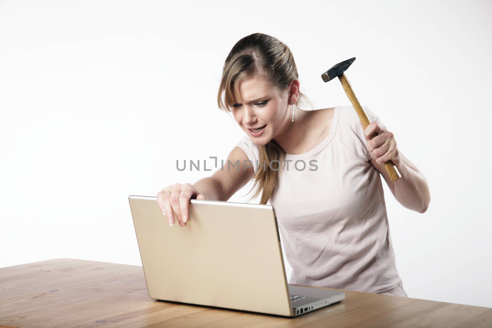 Woman strikes with a hammer to her computer