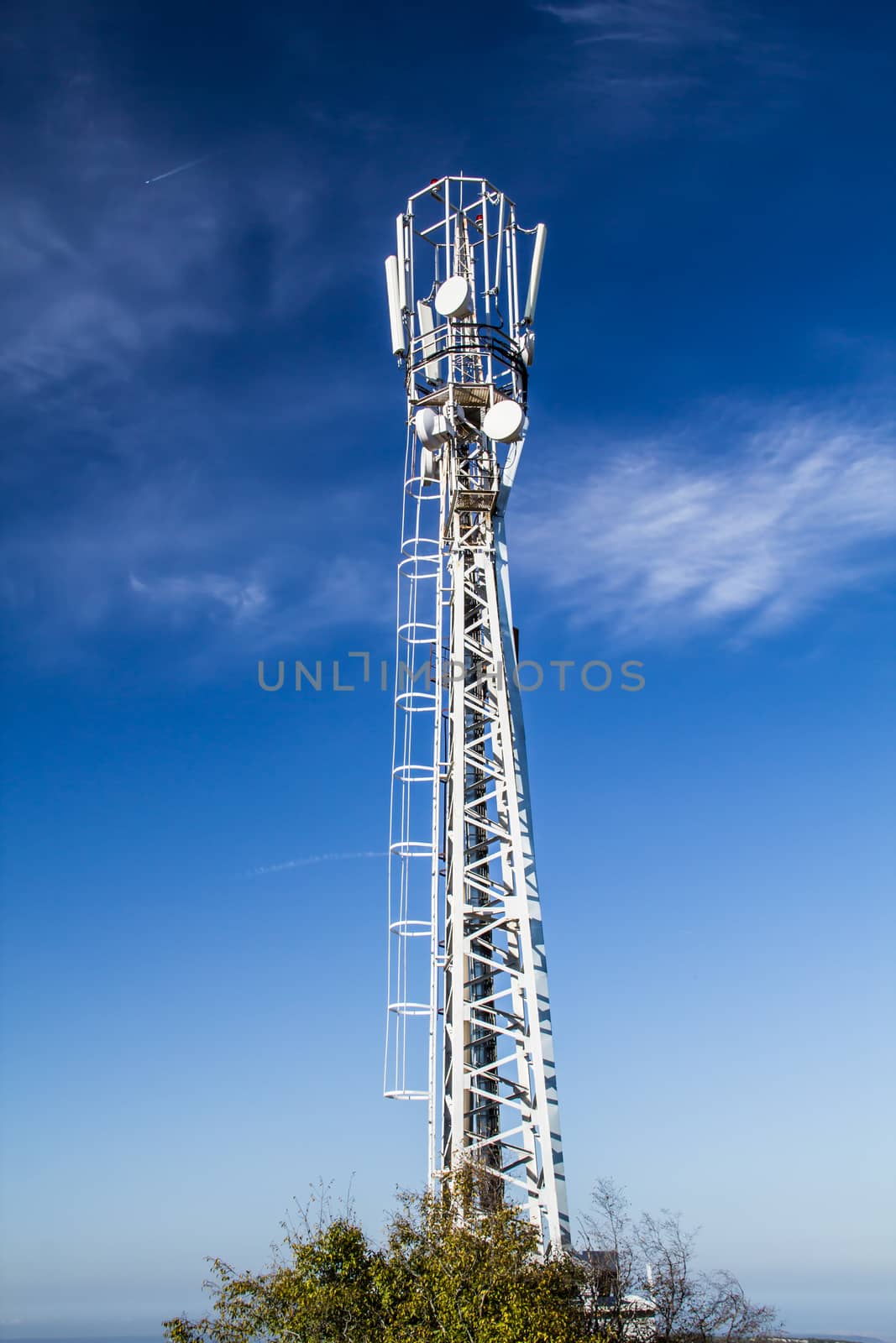 Mast is to accommodate cellular antennas on blue sky background