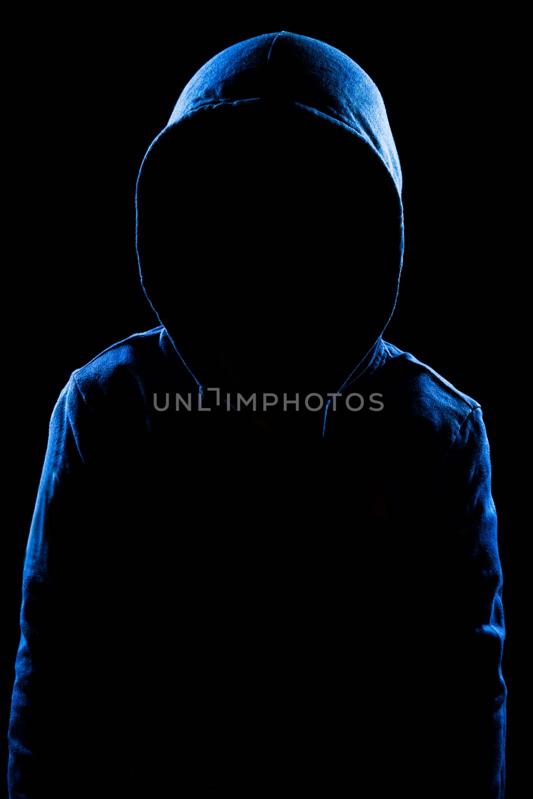 Anonymous user with hood in black background studio shot, faceless.