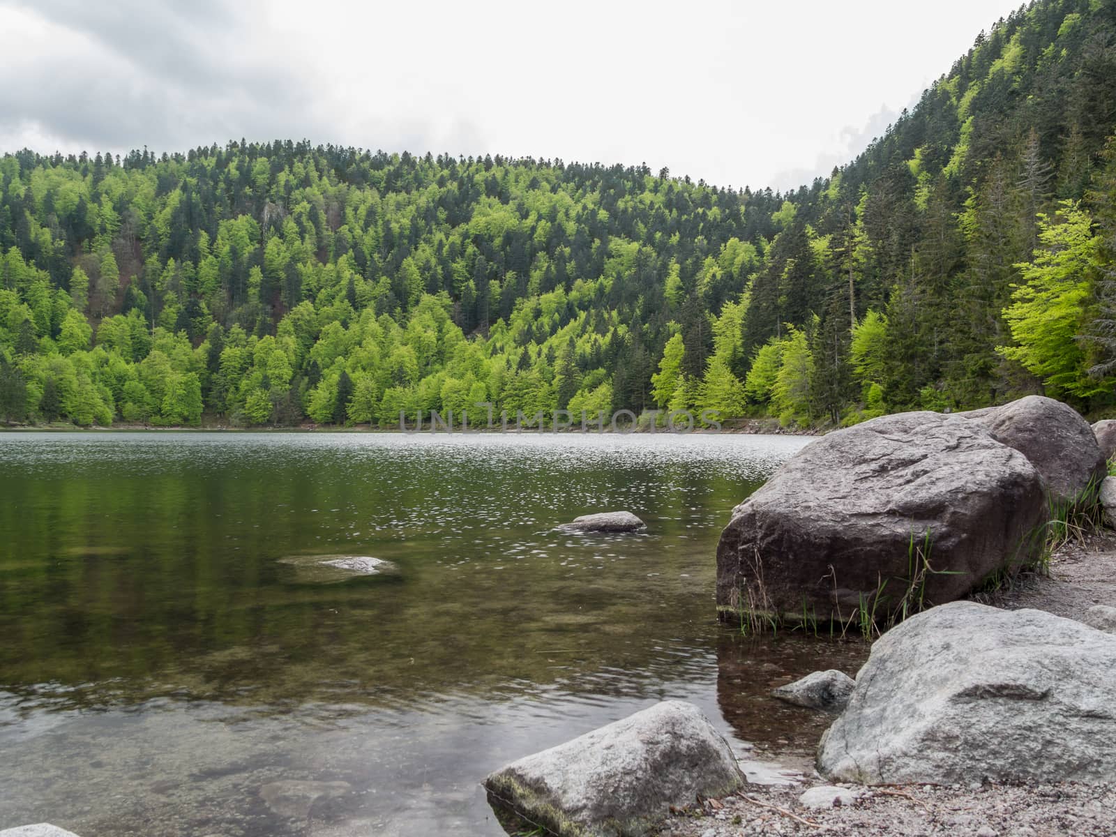 Looking past rocks over lac des corbeaux in France