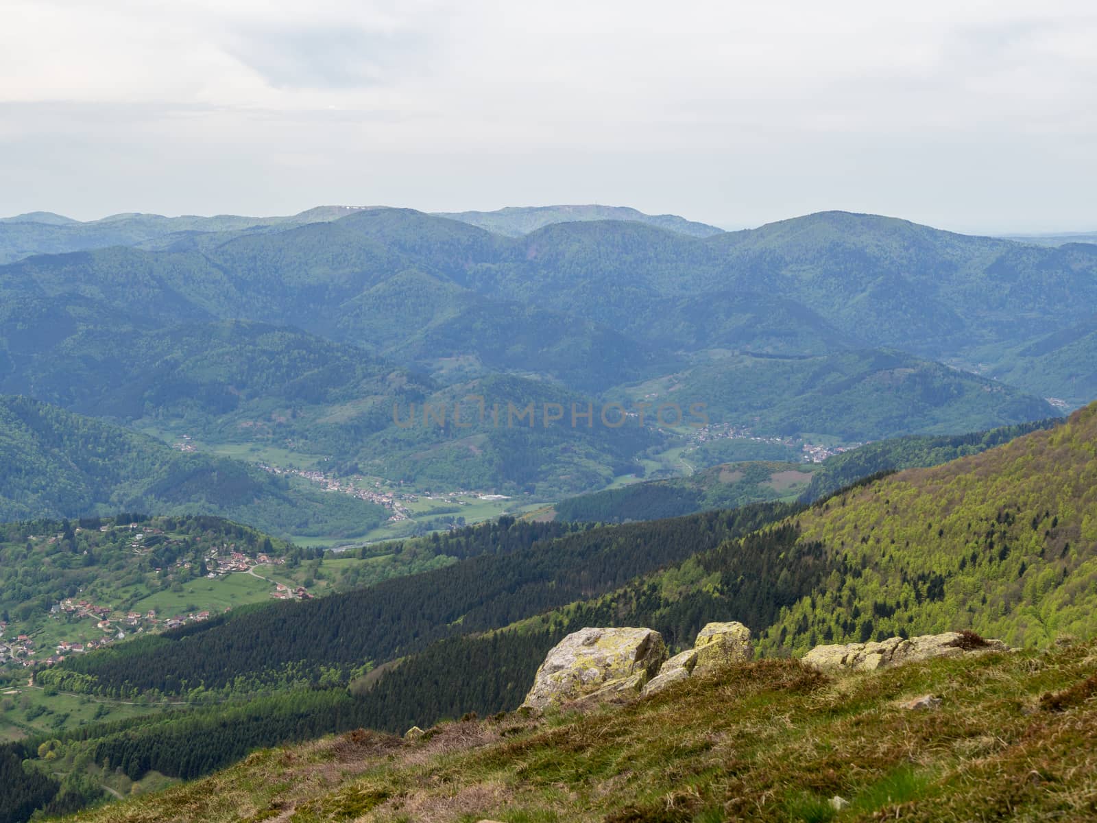 View past rocks looking over villages in the Vosges mountains