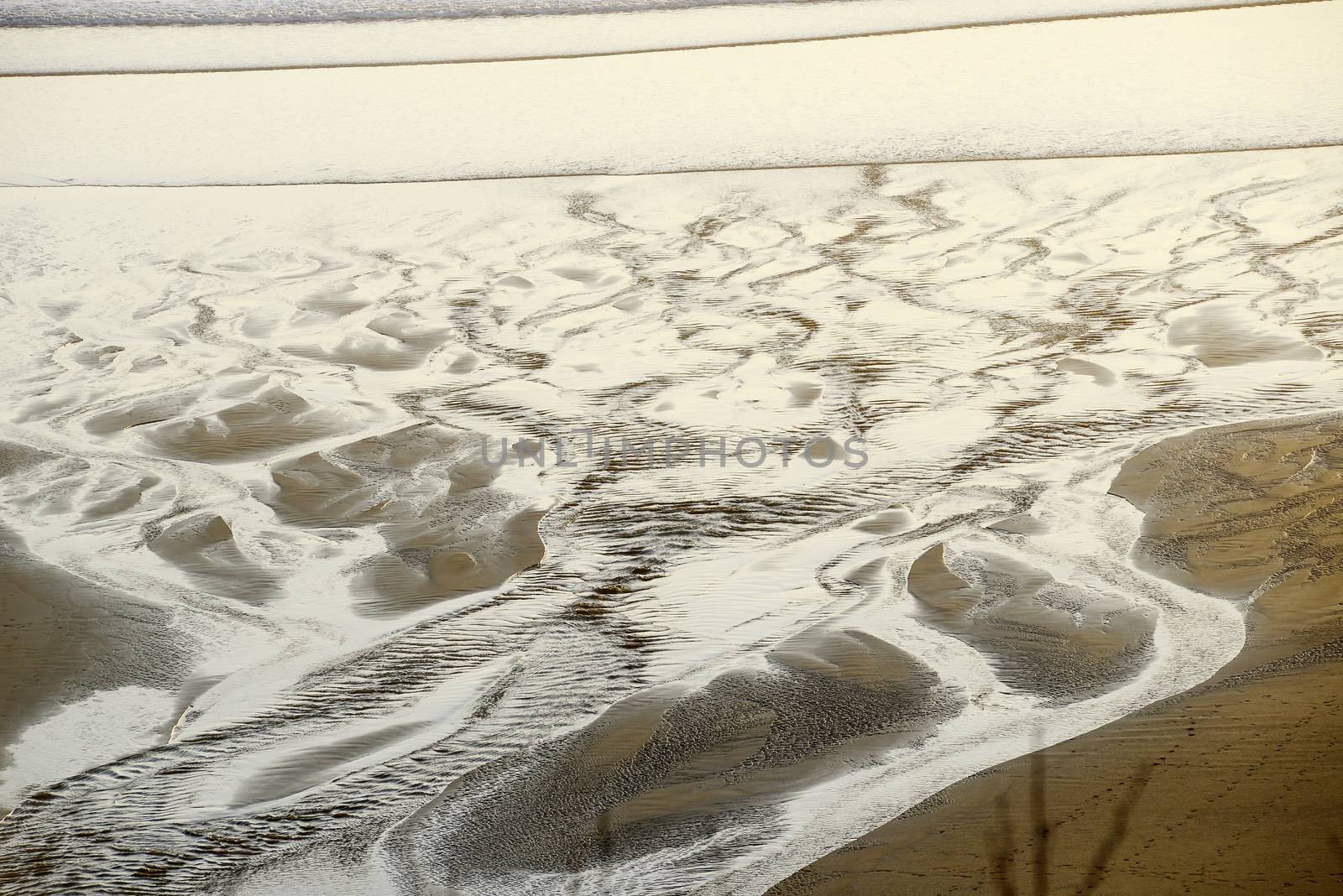 sand pattern from a creek flowing on a beach