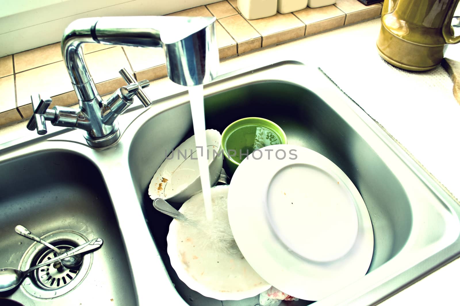 Kitchen conceptual image. Dirty sink with many dirty dishes.