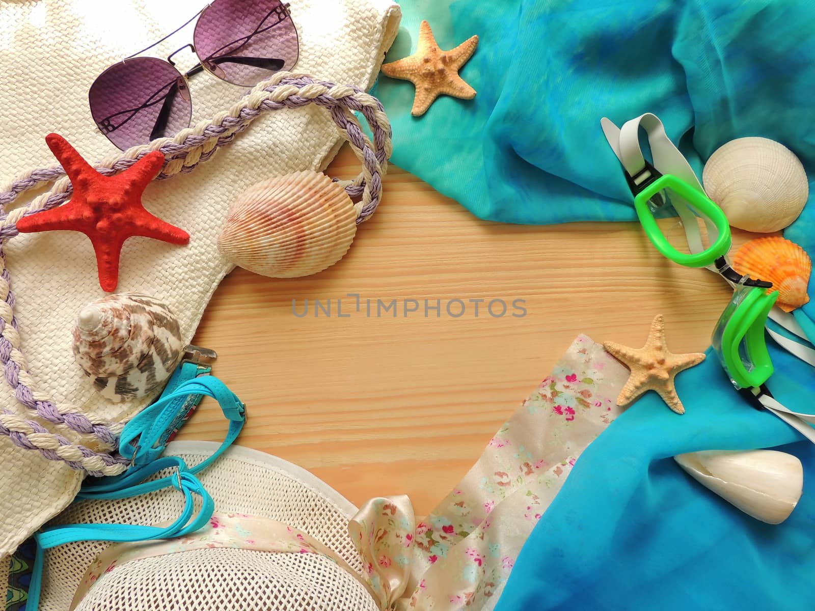 Summer travel background with feminine accessories on a wooden surface.