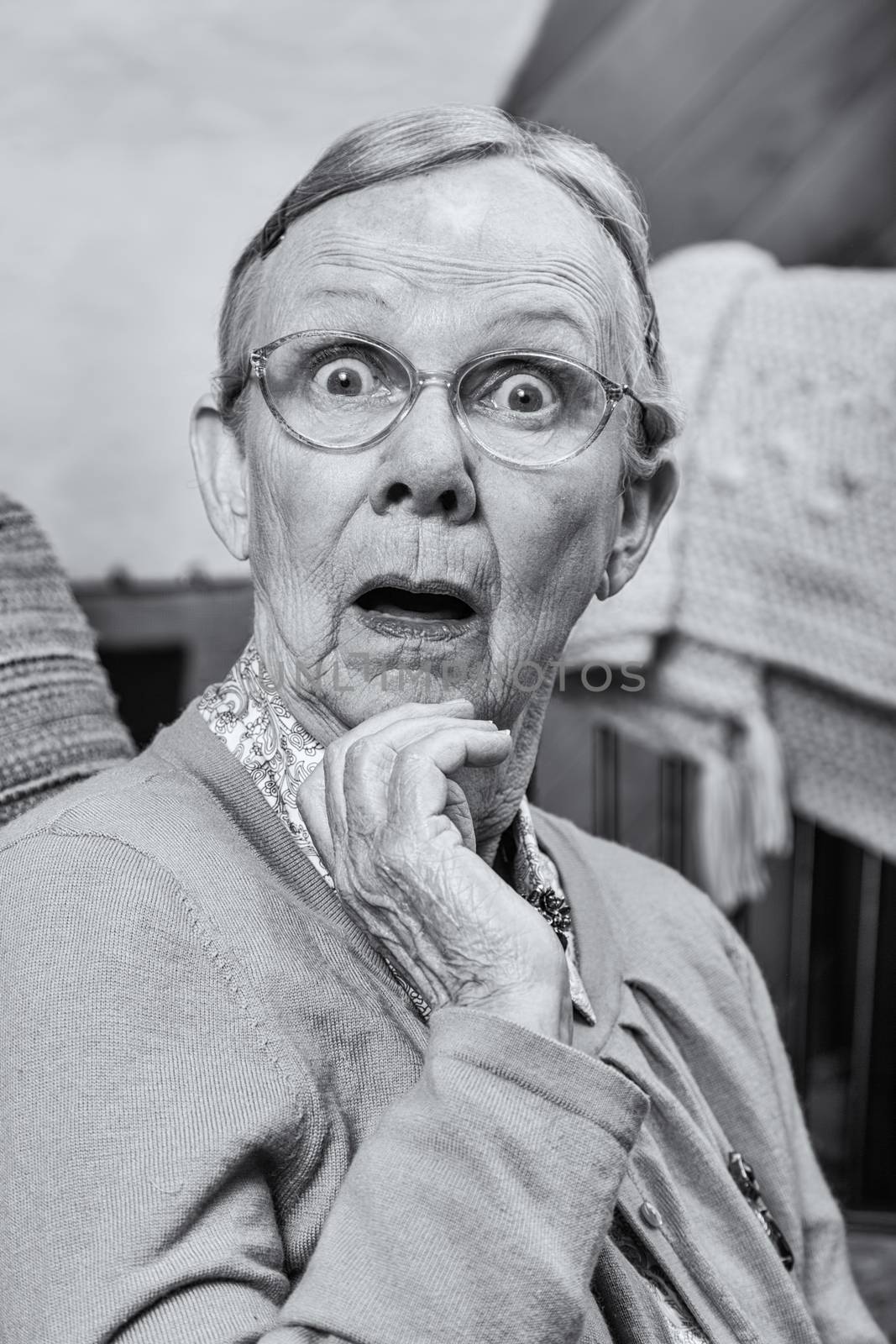 Surprised senior matron woman looking at camera