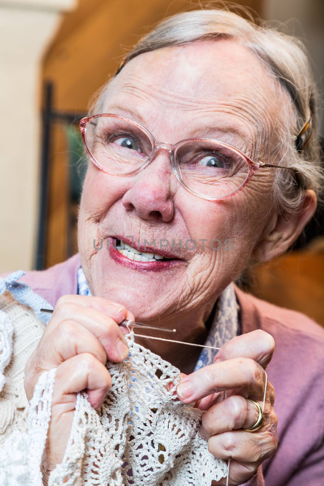 Crazy old lady with crochet and odd expression