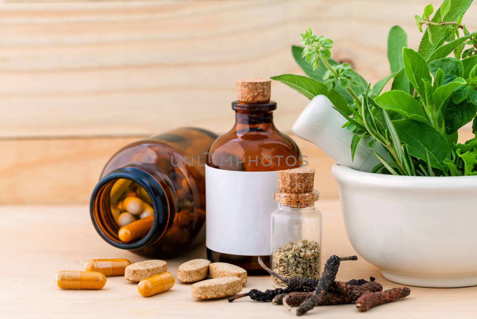 Alternative health care fresh herbal  ,dry and herbal capsule with mortar on wooden background.