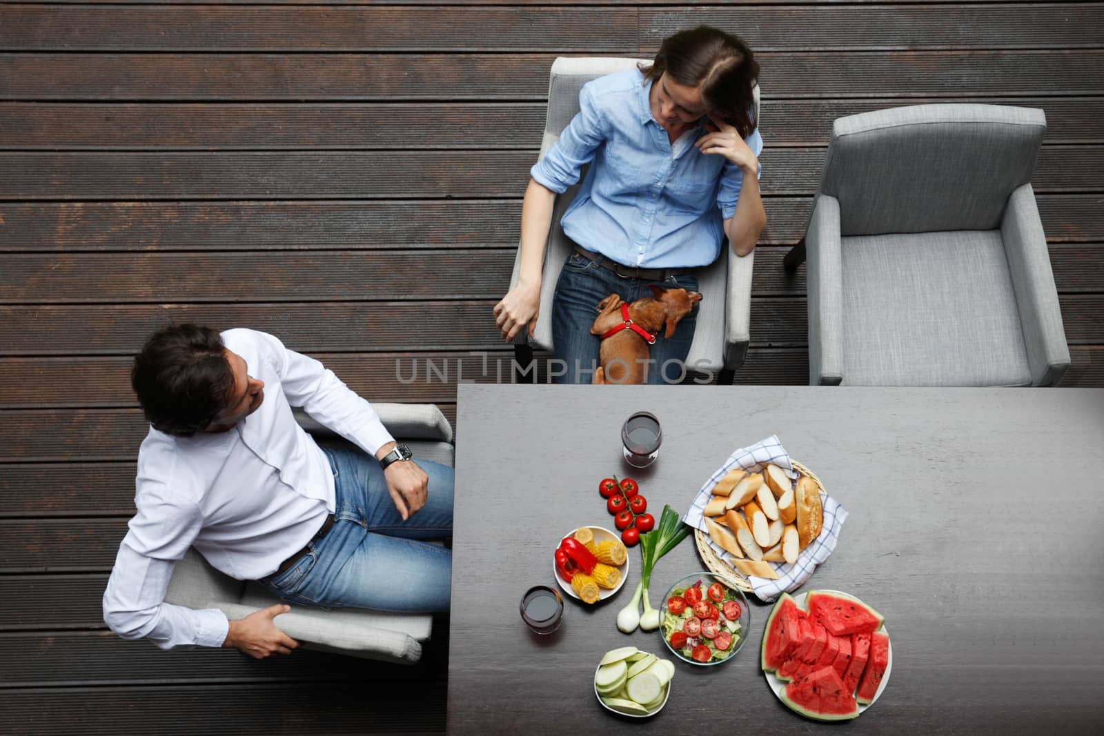 couple eating behind the table from top view