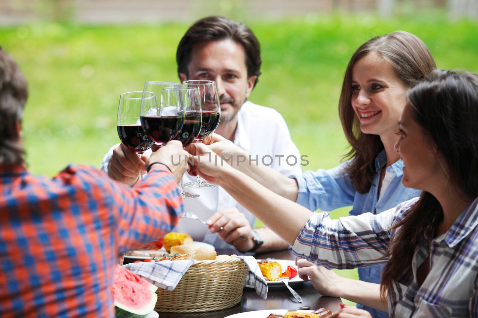 two young couples eating dinner outdoors