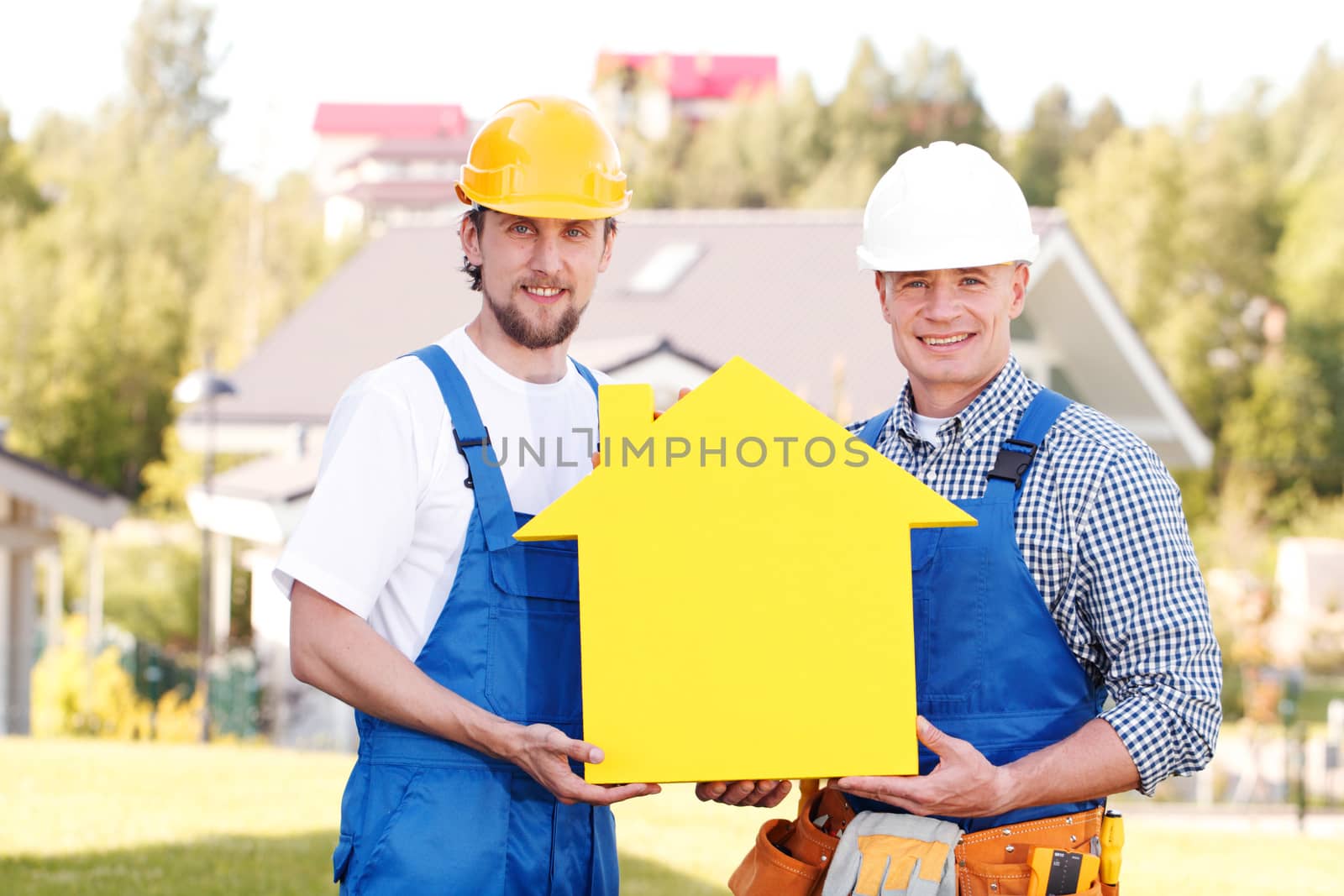 two workmen holding yellow house symbol