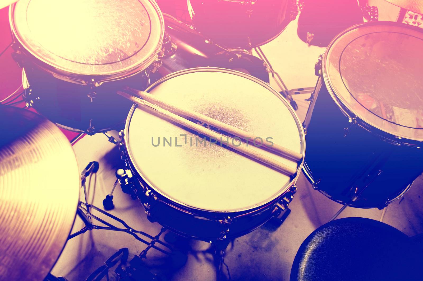 Drums conceptual image. Picture of drums and drumsticks lying on snare drum. Retro vintage instagram picture.