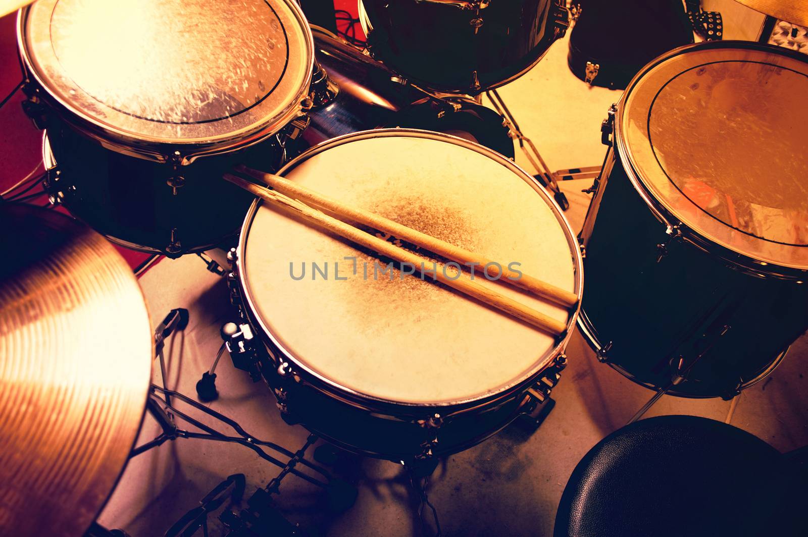 Drums conceptual image. Picture of drums and drumsticks lying on snare drum. Retro vintage instagram picture.