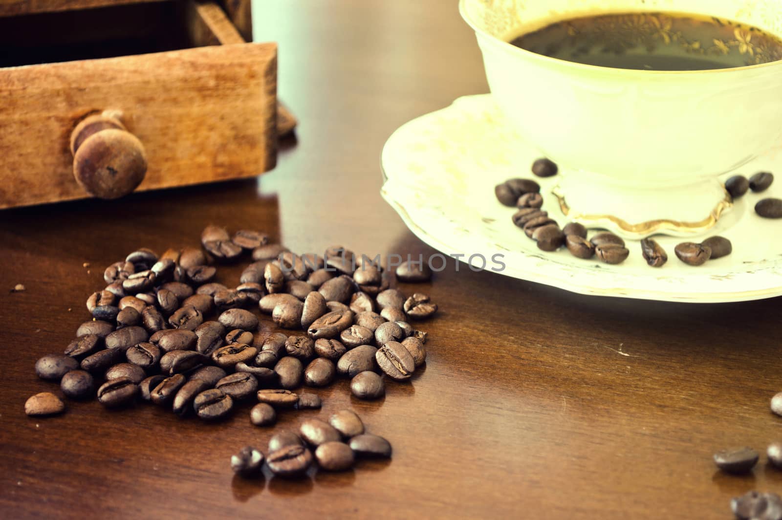 Coffee beans and cup of hot coffee. Vintage instagram picture.