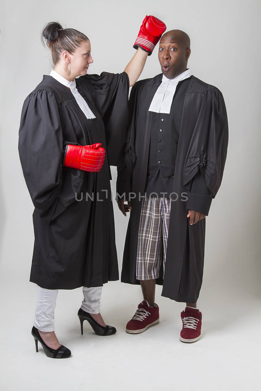 woman punching a man on the head, both wearing canadian lawyers toga