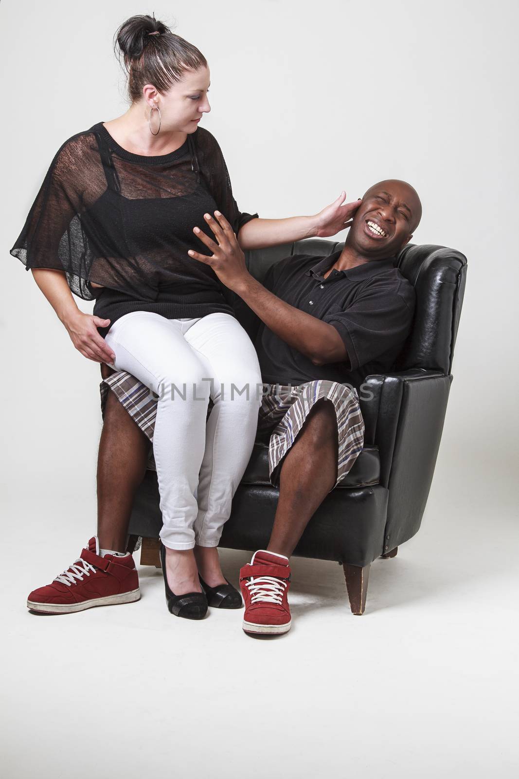 black man grapping the breast of a caucasian woman while she slaps him