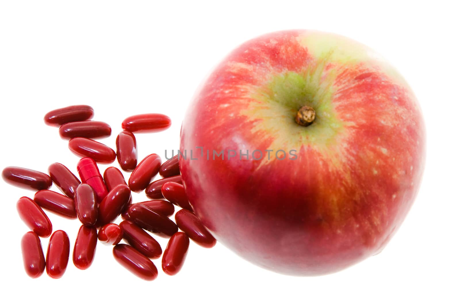 Red Apple and red pill, medicine, isolated on white