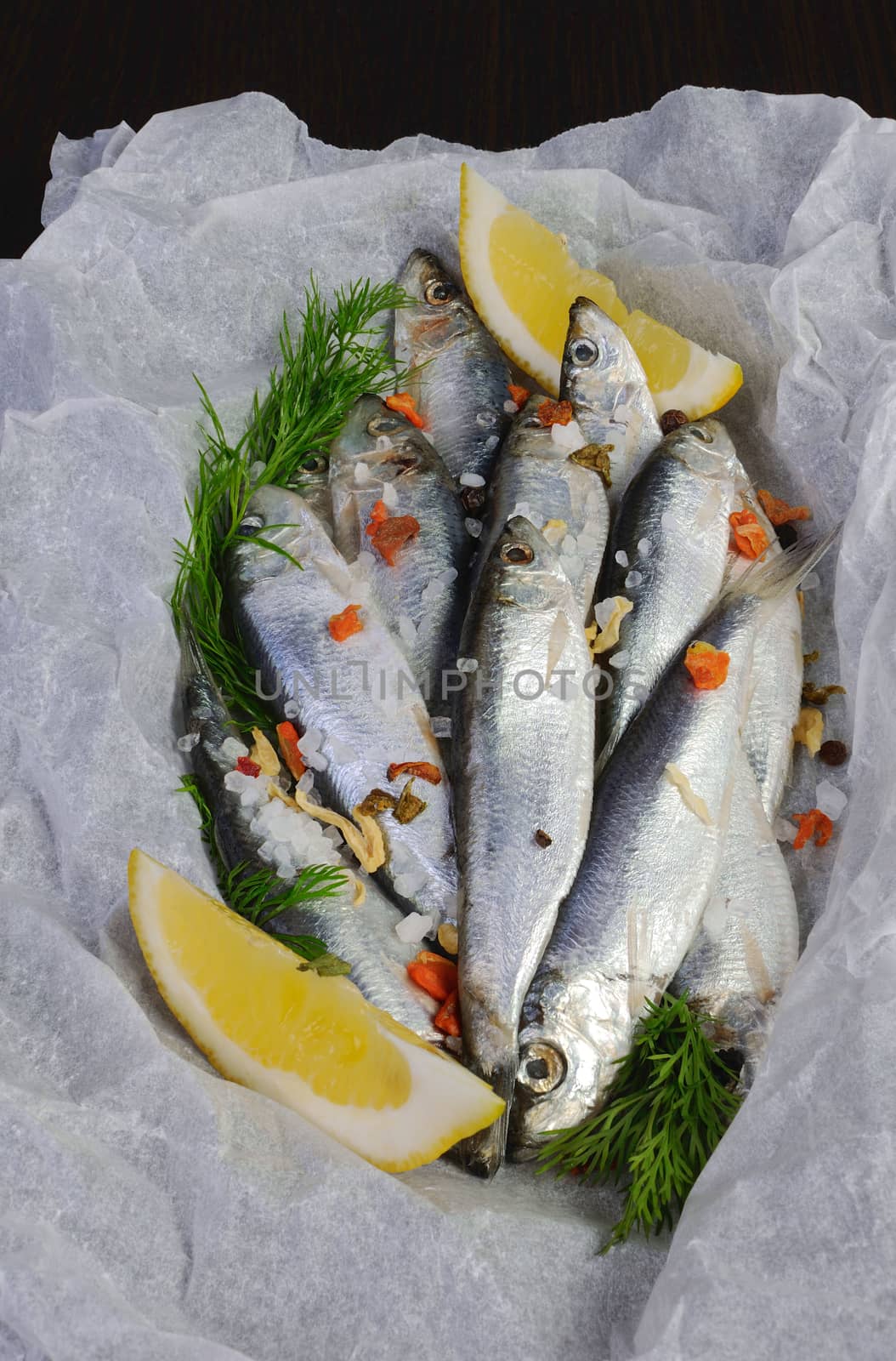 sprat with salt and spices in parchment