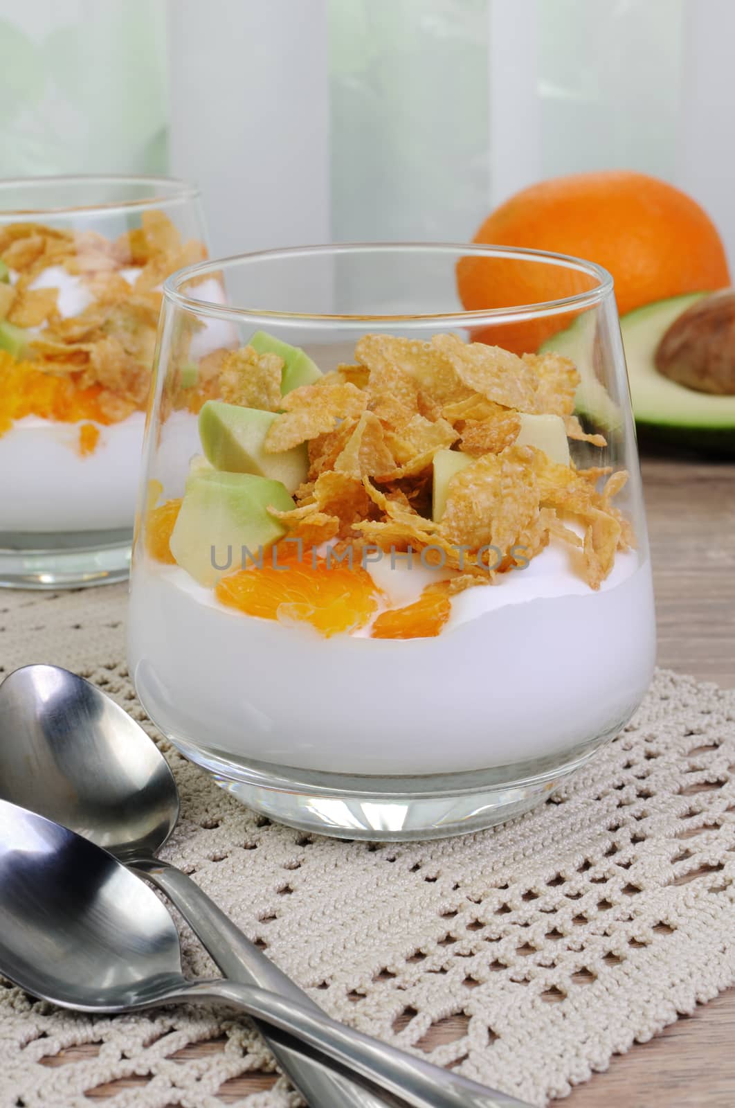 Parfait with slices of orange, avocado and flakes