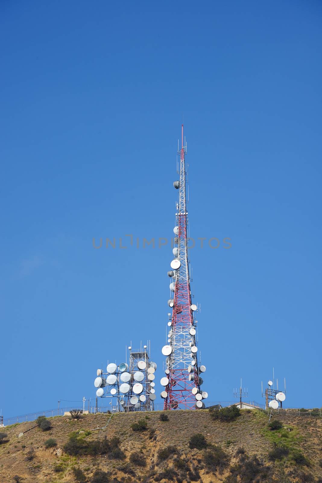 radio antenna on top of mountain with blue sky