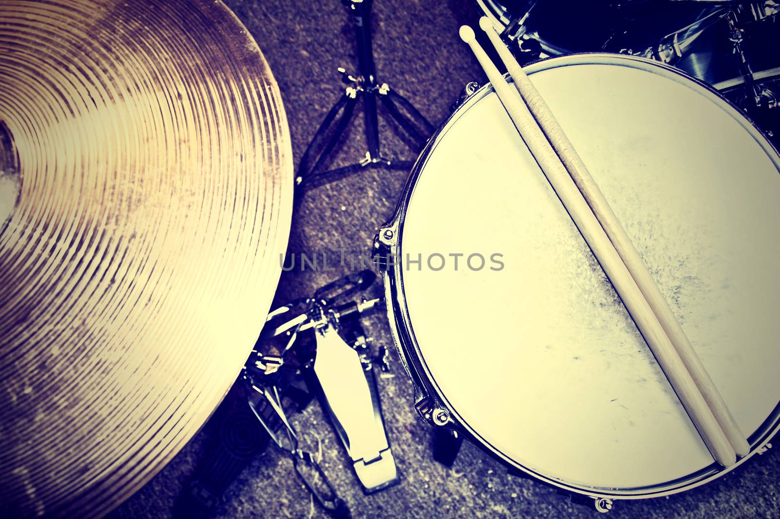 Drums conceptual image. Picture of drums and drumsticks lying on snare drum. Retro vintage instagram picture.