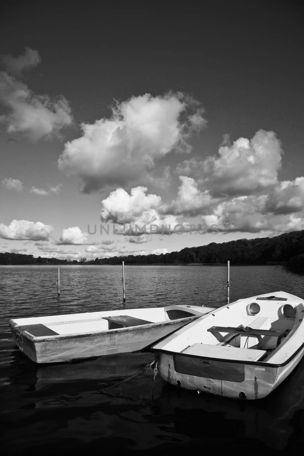 Colorful boats on a lake with cloudy blue sky in Denmark