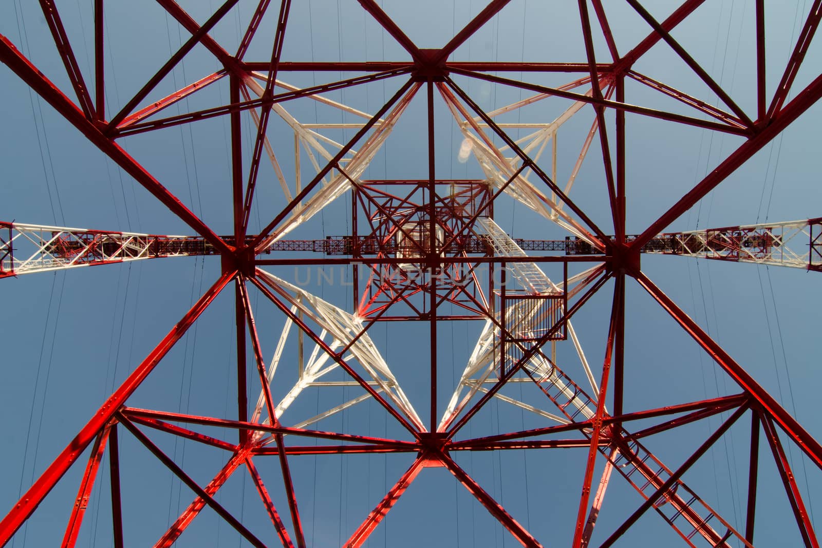 supports of high-voltage power lines against the blue sky