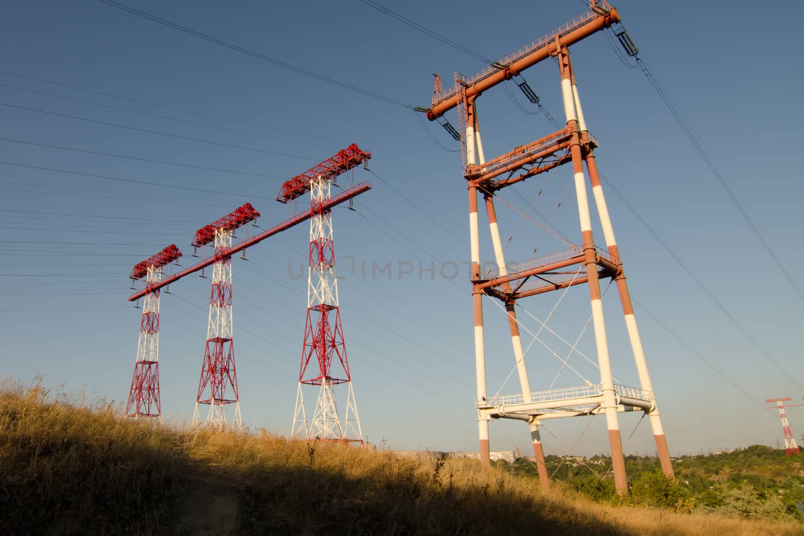 supports of high-voltage power lines against the blue sky