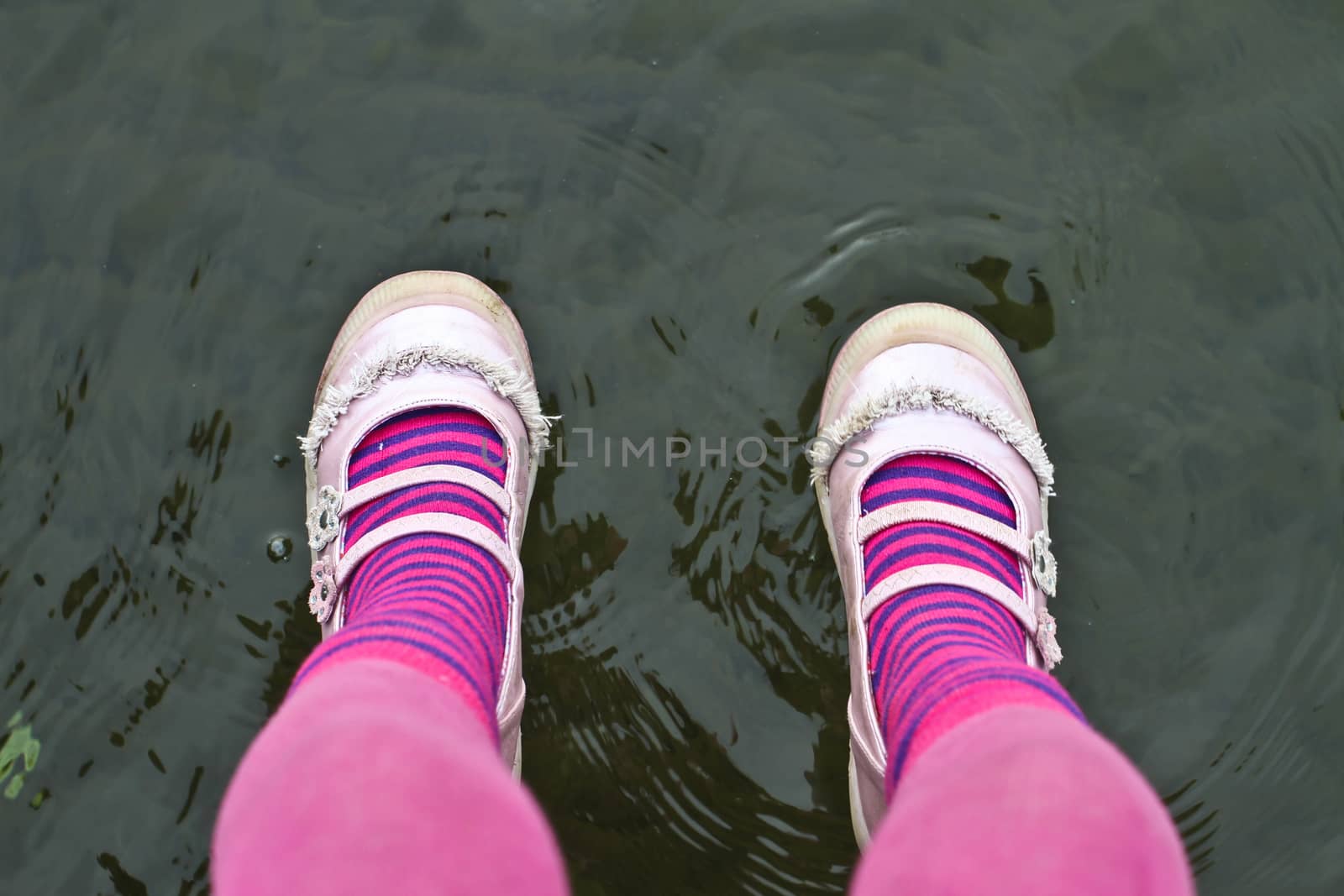 Cute pink legs of a child sitting