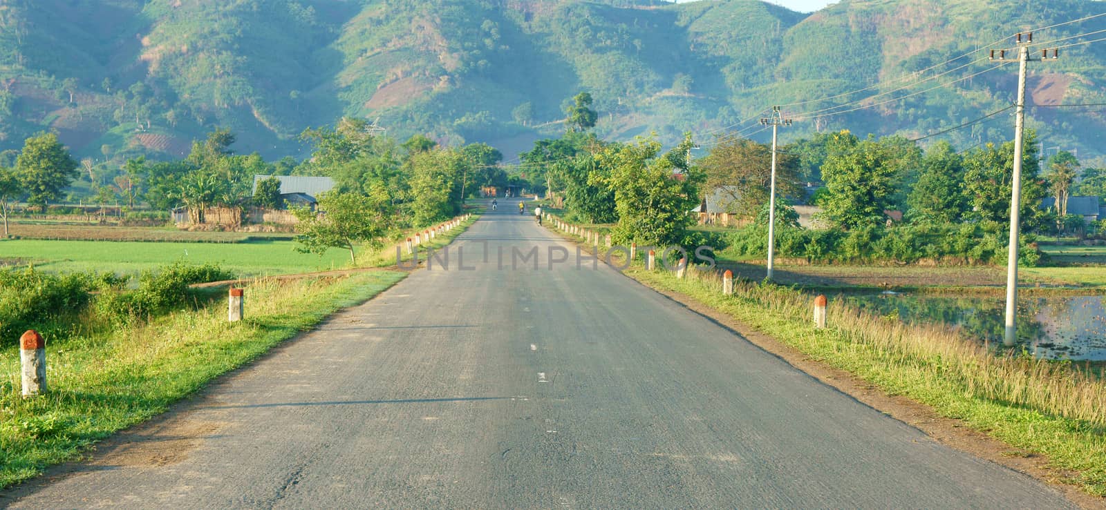 Beautiful Vietnamese countryside landscape, way forward chain of mountain in morning, field along highway, fresh environment, eco green, street like goal or target