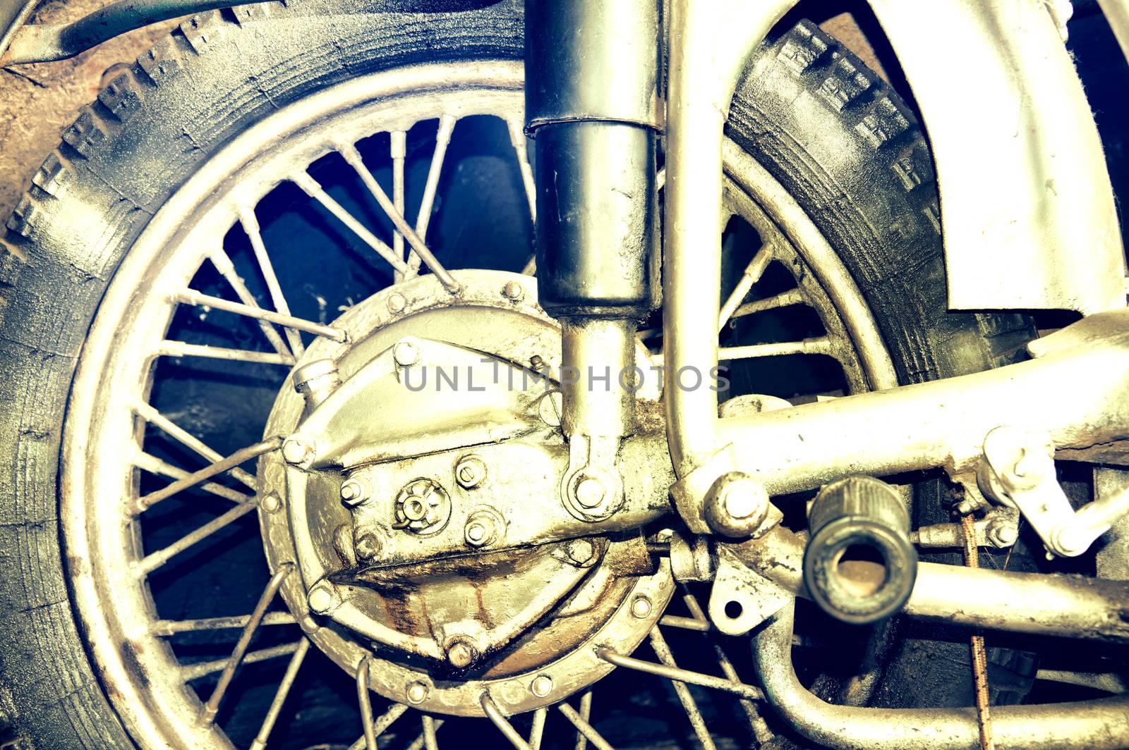 Transportation conceptual image. Motorcycle tire. Part of old motocycle. Creamy pastel vintage picture