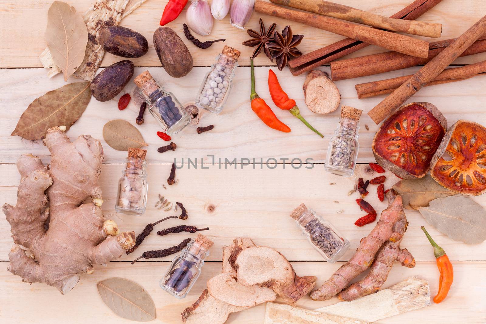 Assortment of Thai food Cooking ingredients in glass bottles on wooden background.