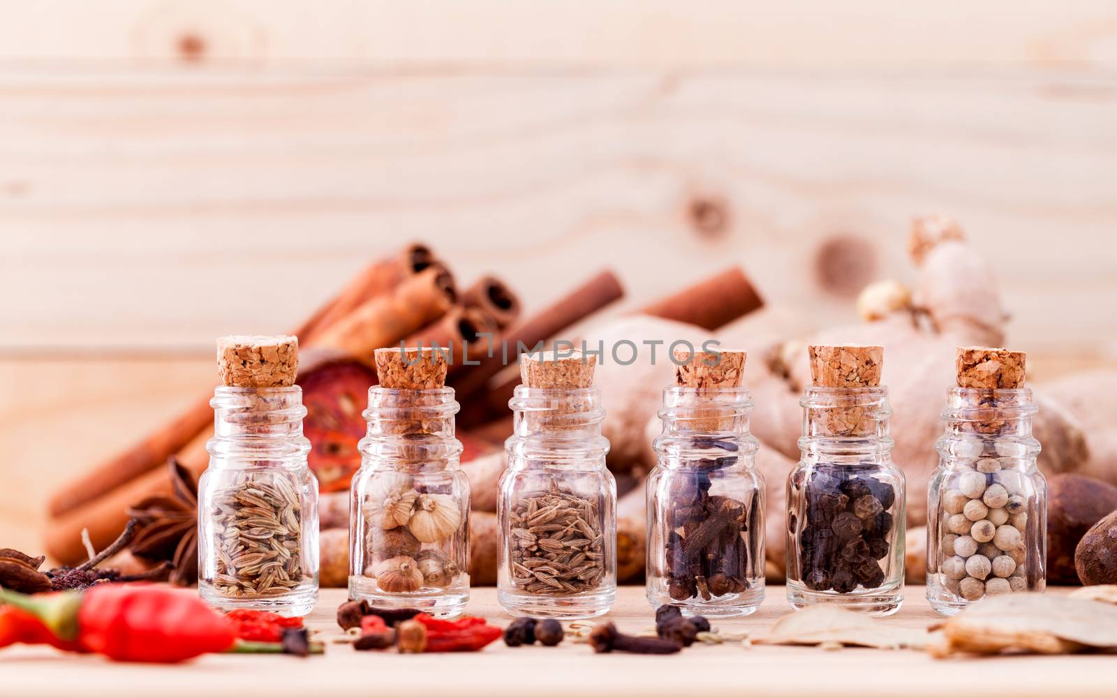 Assortment of Thai food Cooking ingredients in glass bottles on wooden background.