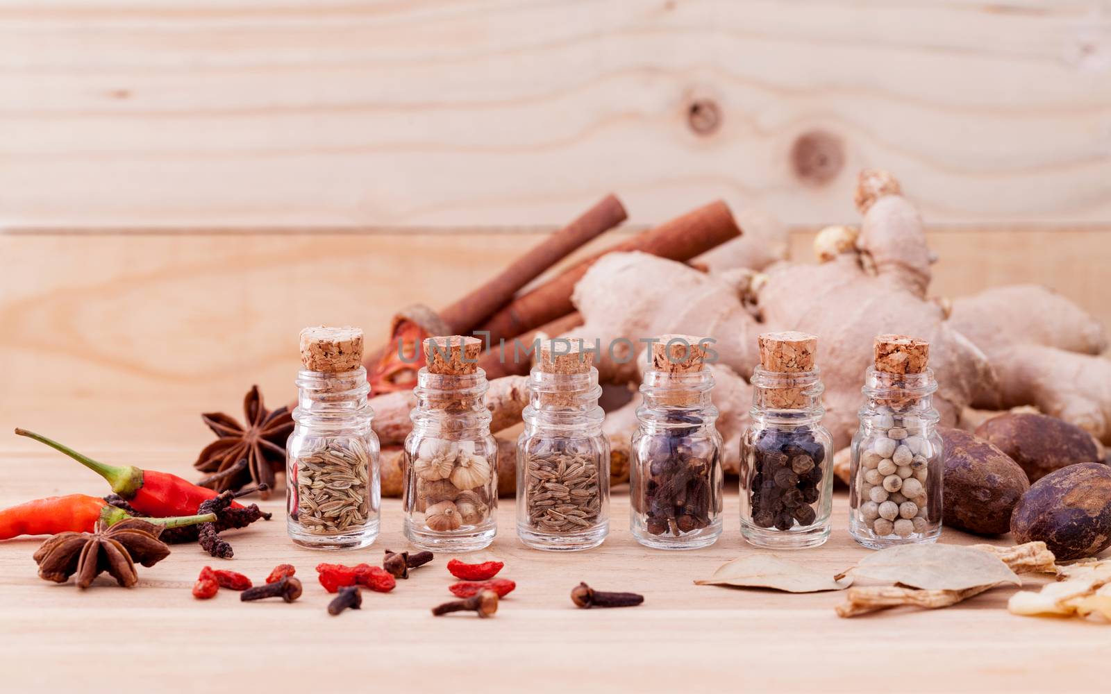 Assortment of Thai food Cooking ingredients in glass bottles on wooden background.