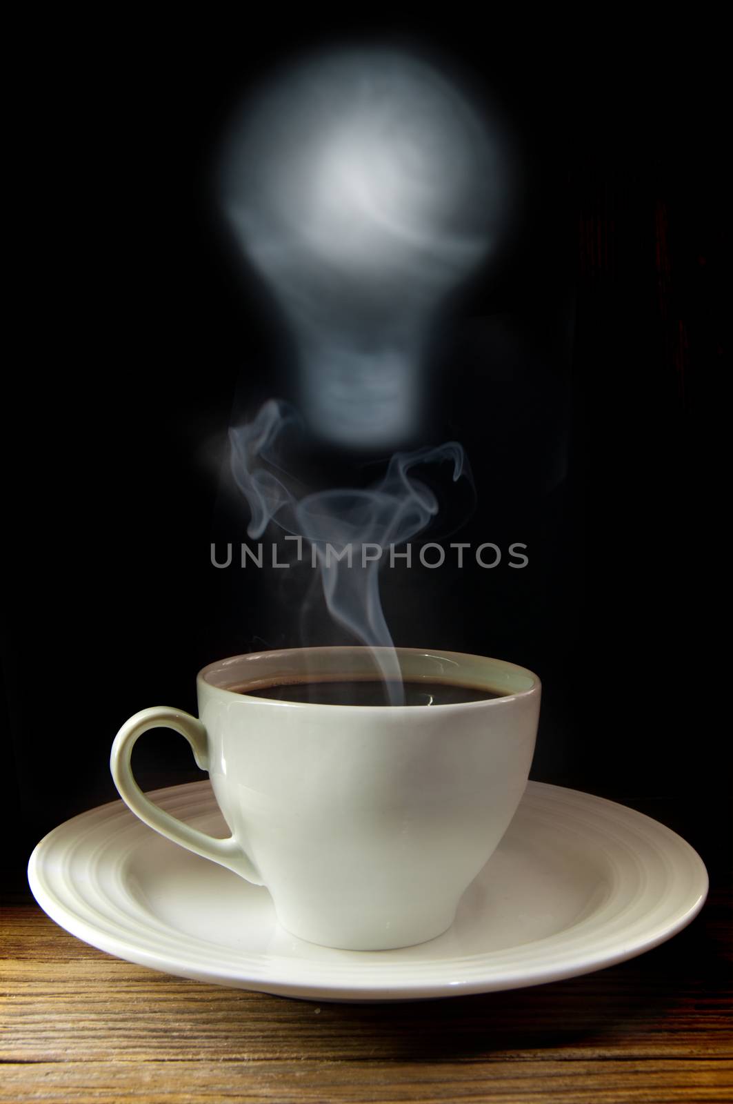 Hot coffee with steam forming the shape of a light bulb symbolising inspiration and new ideas 