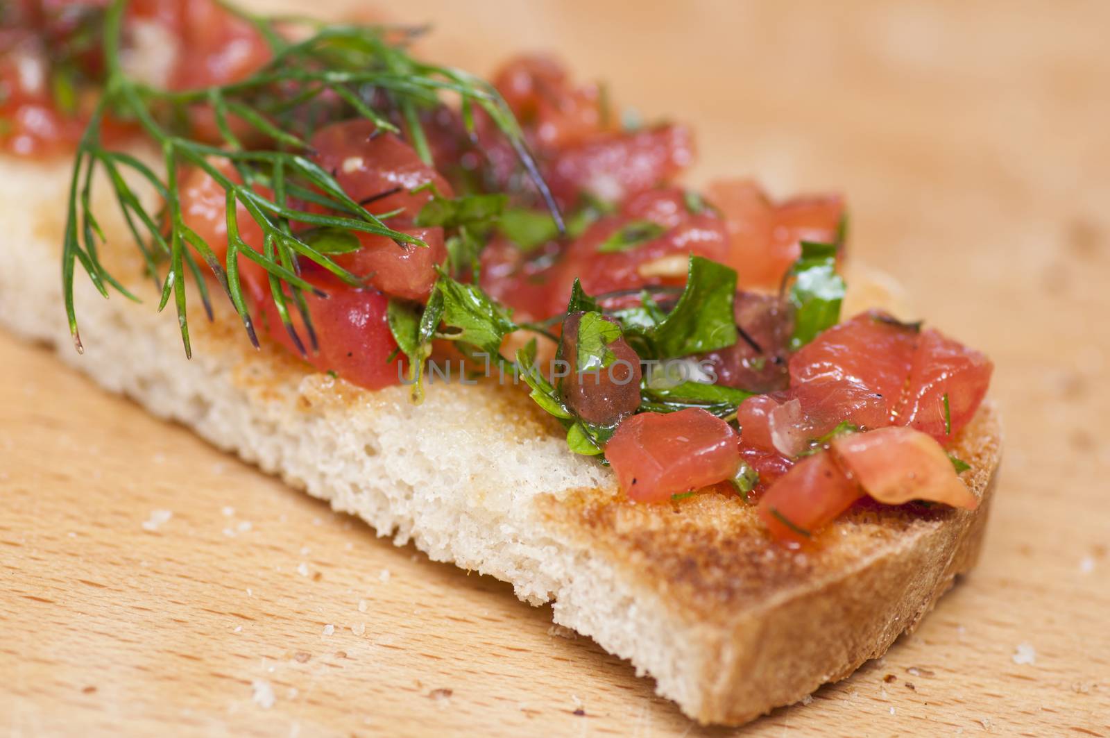 Italian bruschetta topped with tomatoes and dill