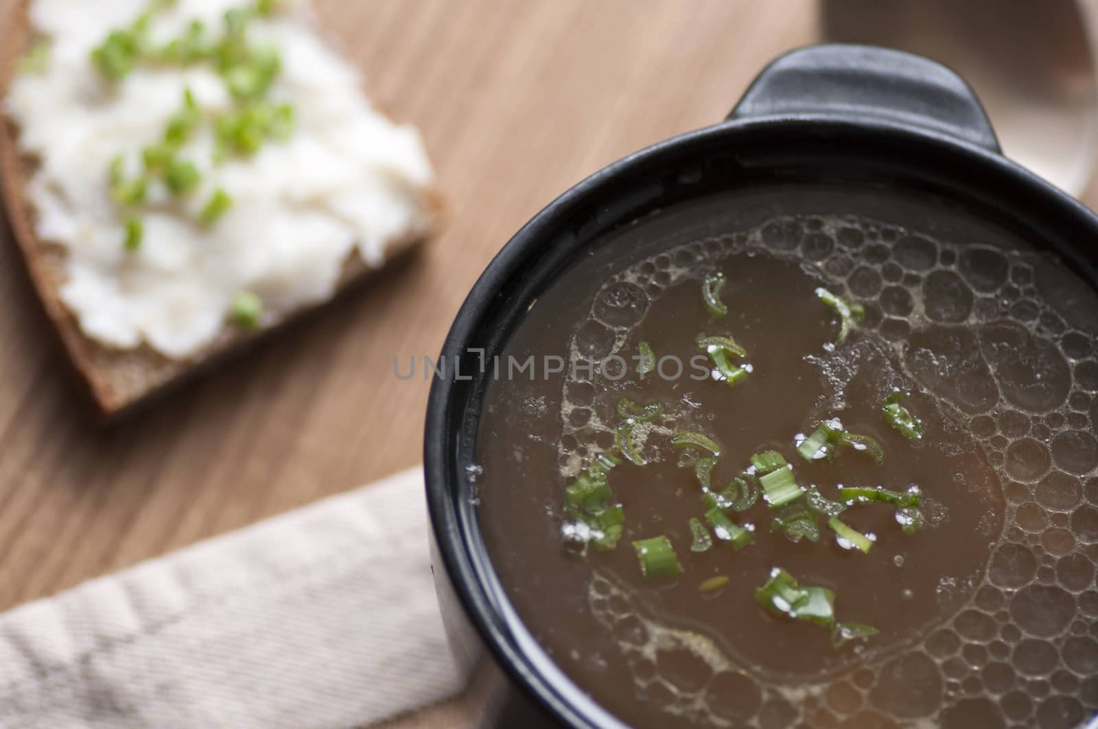 Mushroom soup served with lard spread on rye bread with green onion view from above