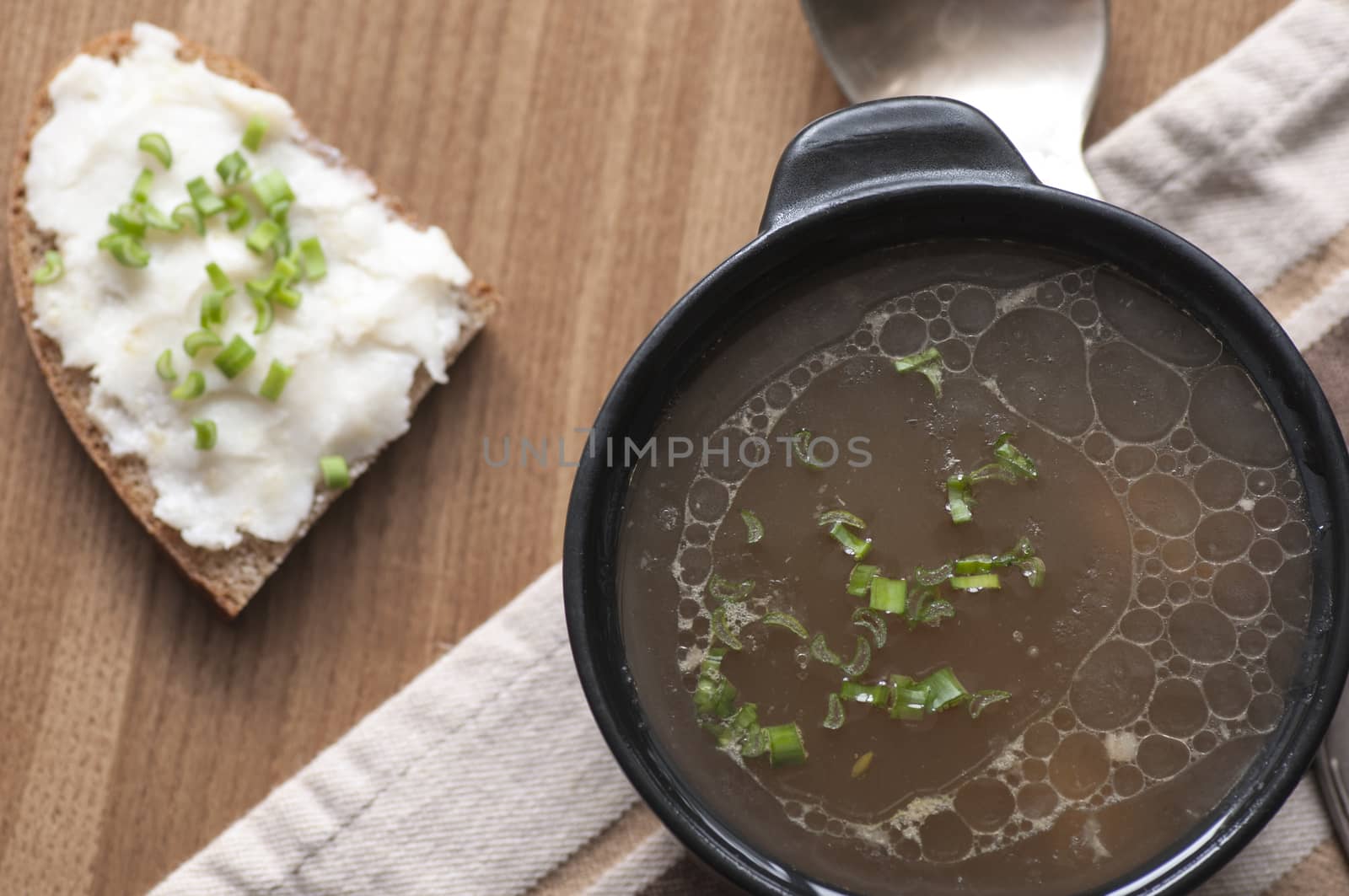 Mushroom soup served with lard spread on rye bread with green onion view from above