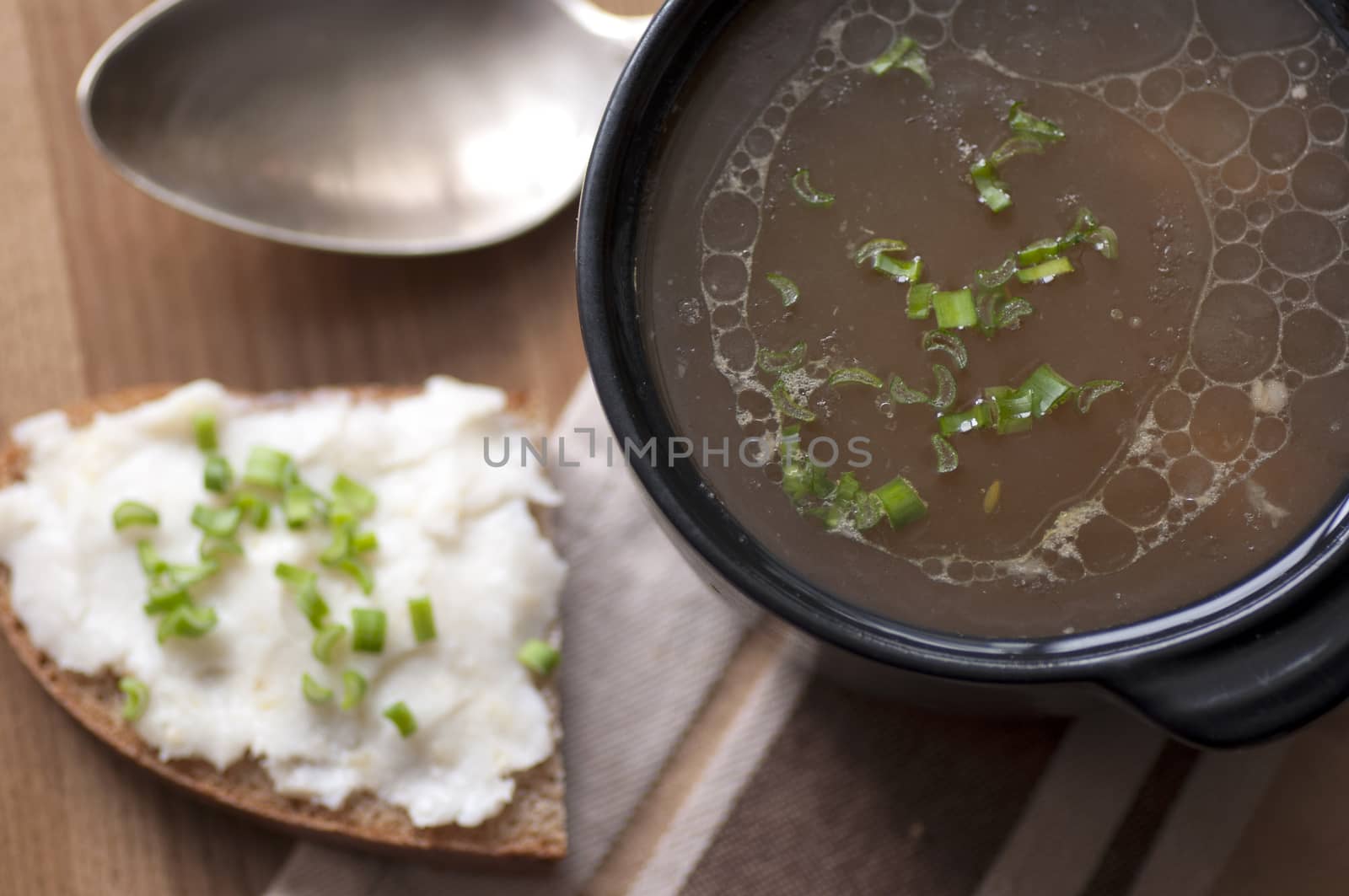 Mushroom soup served with lard spread with green onion by dred