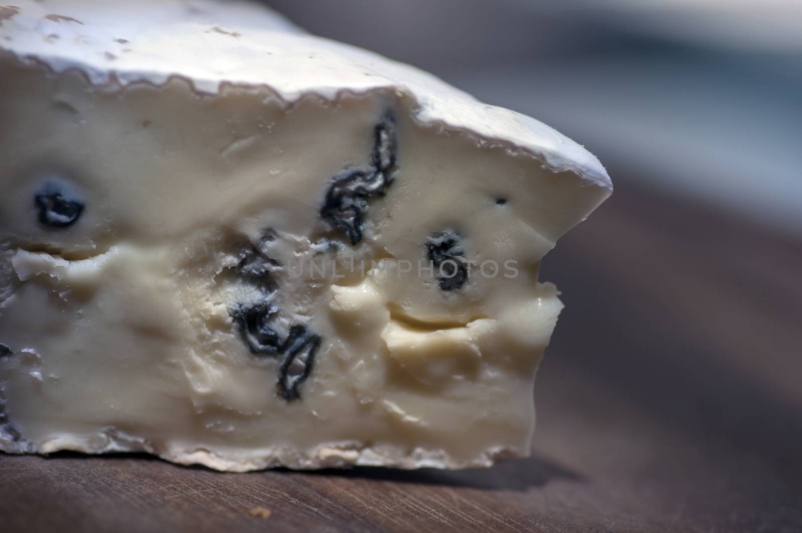 Cambozola cheese (combination of camembert and gorgonzola cheeses) on cutting board close up