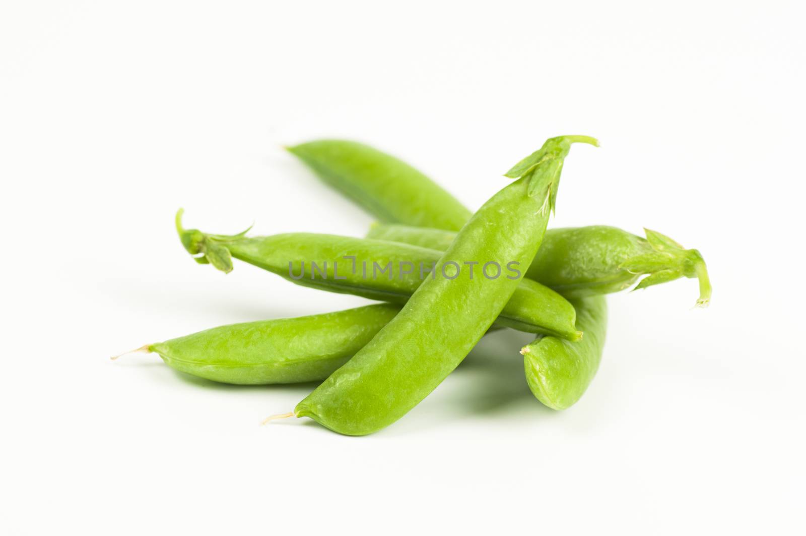 Ripe green organic peas in the pod isolated on white