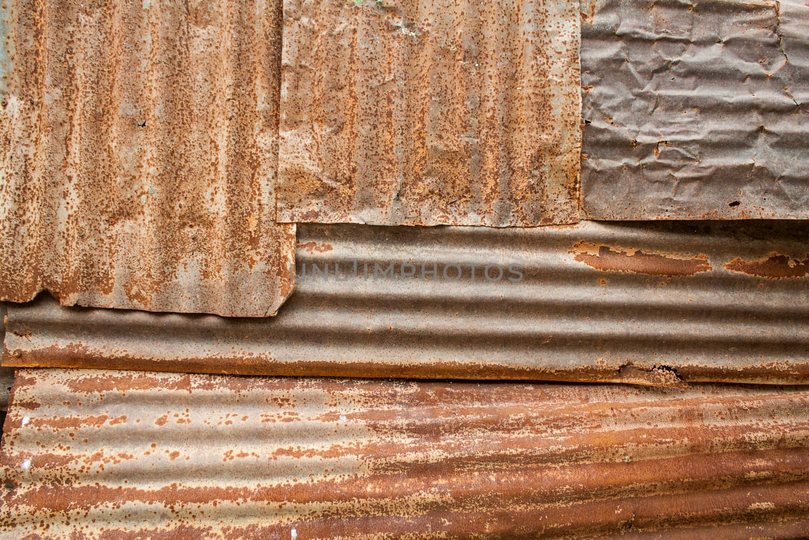 A rusty corrugated iron metal fence close up/ Zinc wall  by kritsada1992