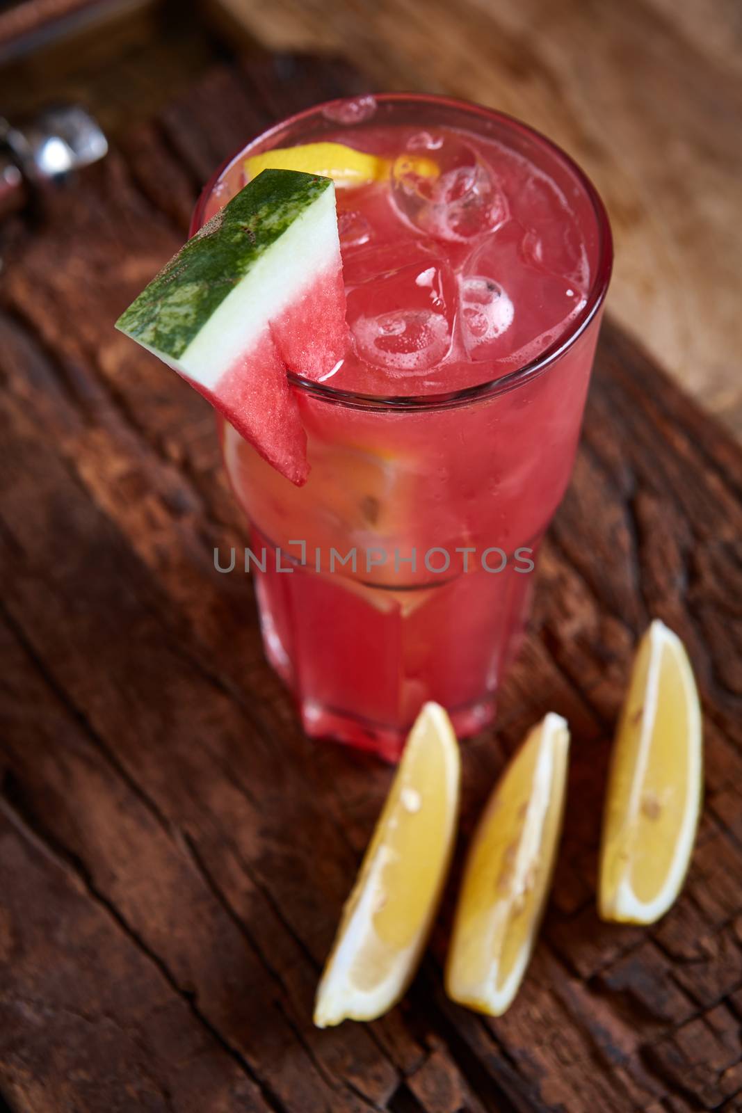 Homemade watermelon lemonade with mint and lemon in glasses and slices of watermelon