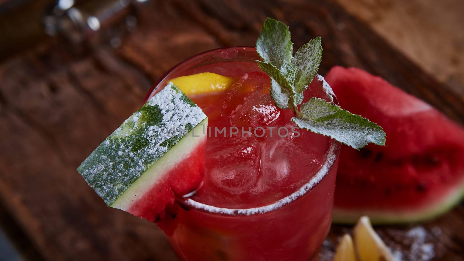 Homemade watermelon lemonade with mint and lemon in glasses and slices of watermelon