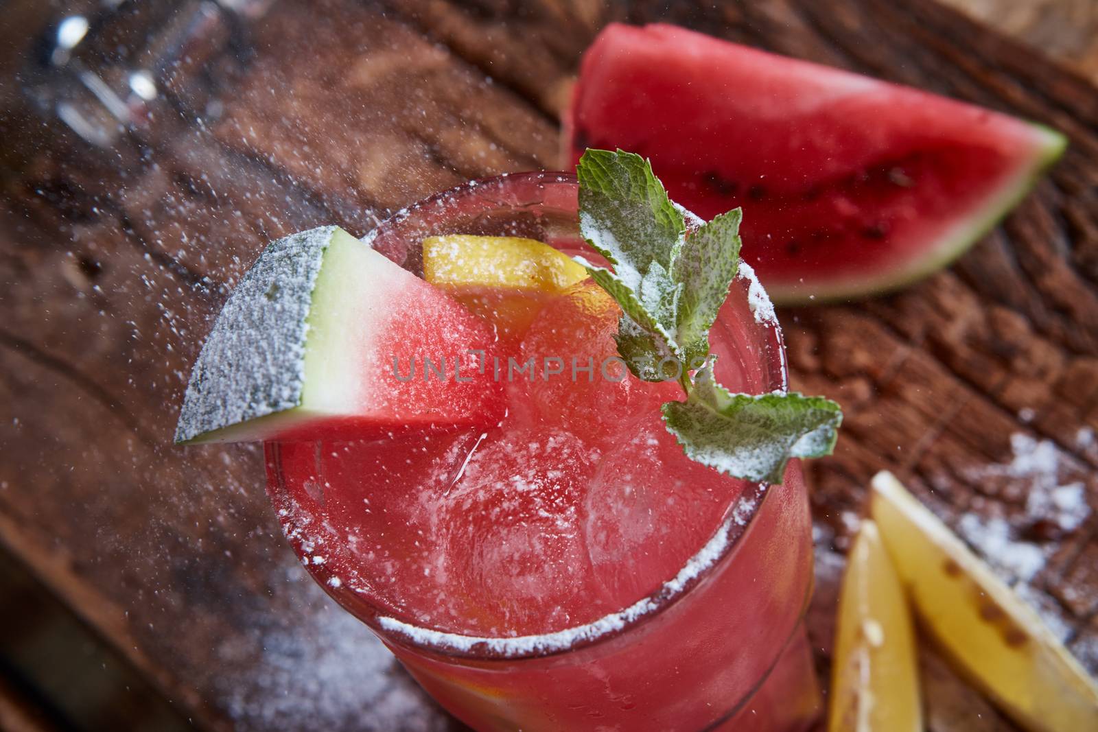 Homemade watermelon lemonade with mint and lemon in glasses and slices of watermelon