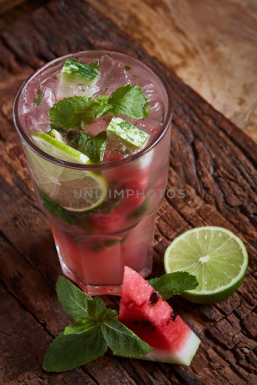 Homemade watermelon lemonade with mint and lime in glasses and slices of watermelon