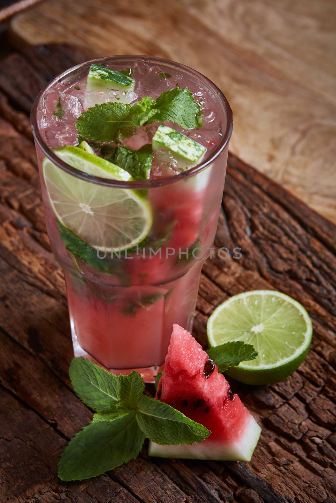 Homemade watermelon lemonade with mint and lime in glasses and slices of watermelon