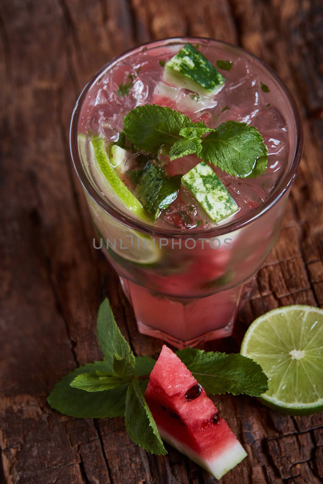 Homemade watermelon lemonade with mint and lime in glasses and slices of watermelon